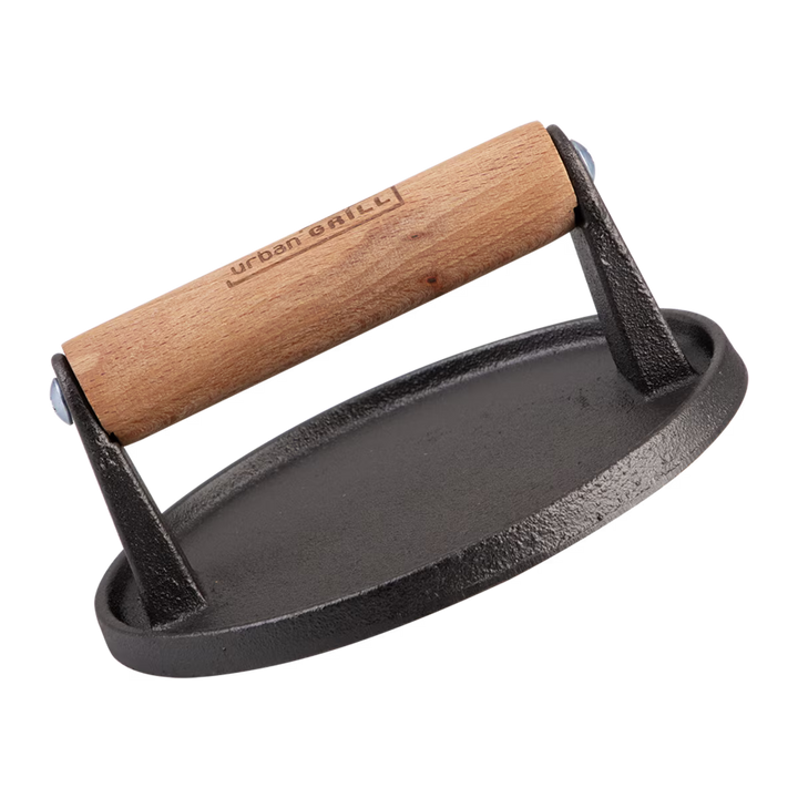 Black cast iron burger press with wooden handle on a white background