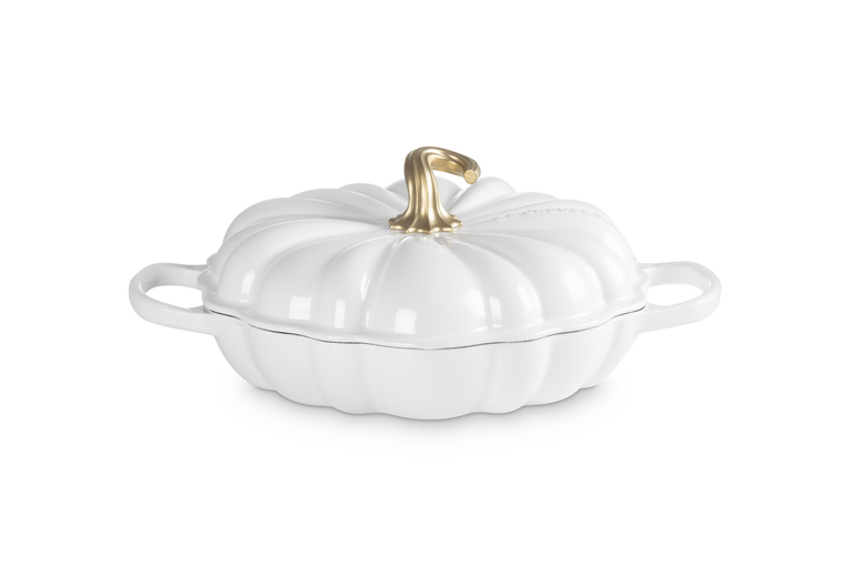 A white pumpkin-shaped lidded casserole dish with side handles and a metallic gold stem on a clean white background.