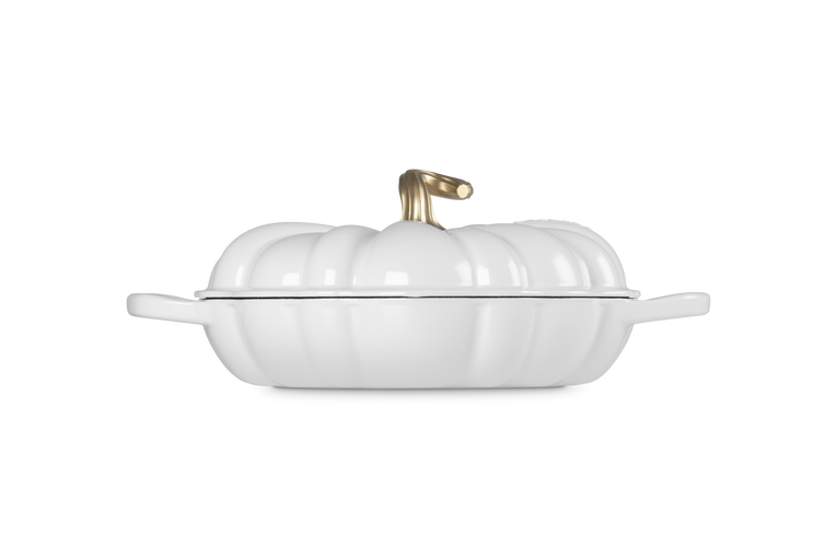 A white pumpkin-shaped lidded casserole dish with a gold-toned handle shown on a clean white background.