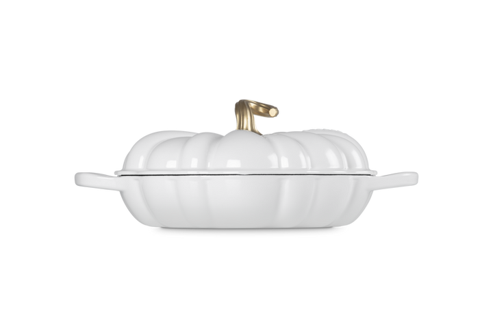 A white pumpkin-shaped lidded casserole dish with a gold-toned handle shown on a clean white background.