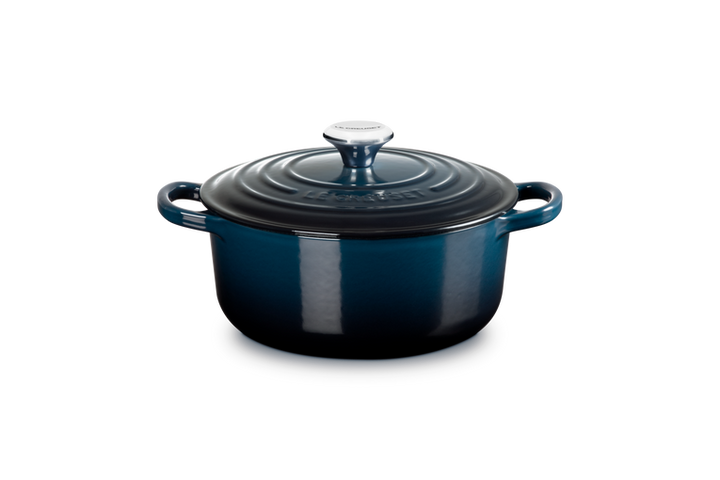 Blue enameled cast iron Dutch oven on a white background