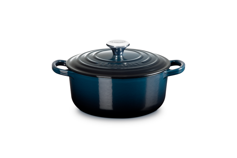 Blue enameled cast iron Dutch oven on a white background