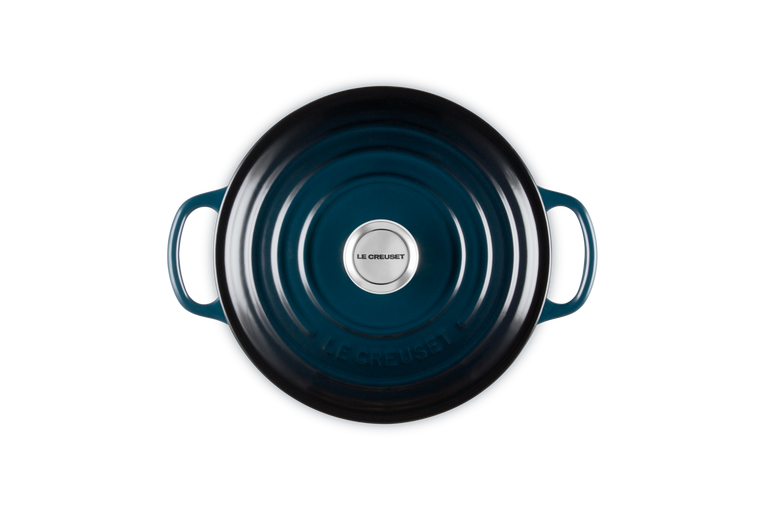 Blue cast iron cookware with a visible brand logo on a white background