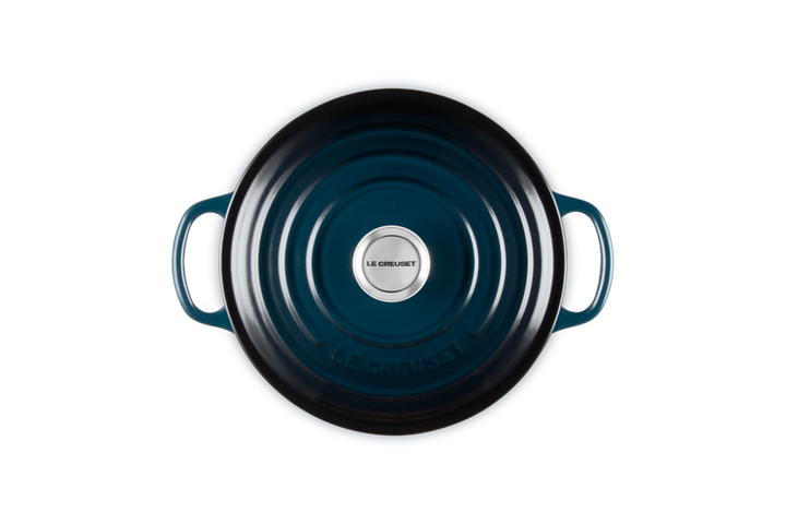 Blue cast iron cookware with a visible brand logo on a white background