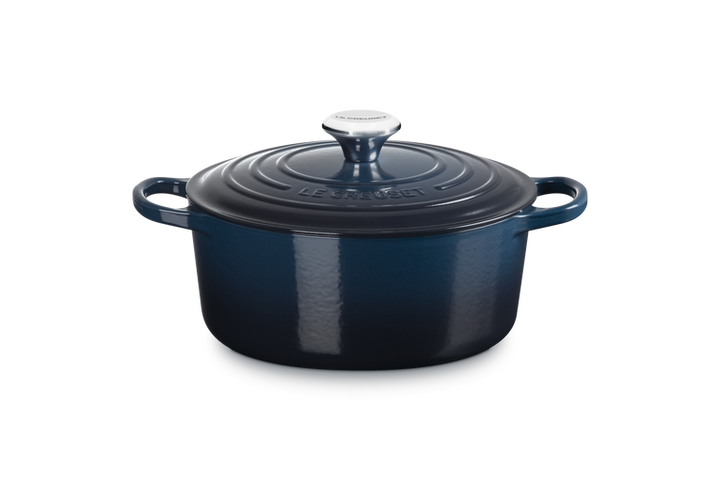 Blue enameled cast iron Dutch oven on a white background