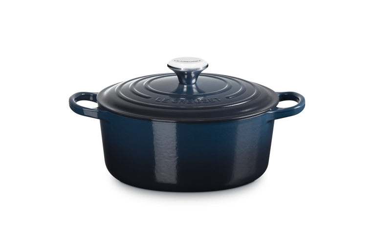 Blue enameled cast iron Dutch oven on a white background