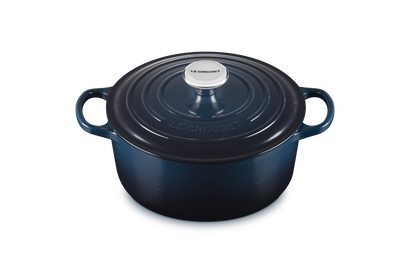 Blue enameled cast iron round Dutch oven on a white background