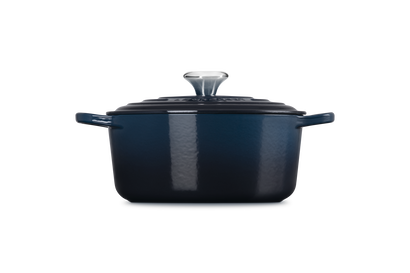 Blue enameled cast iron Dutch oven on a white background
