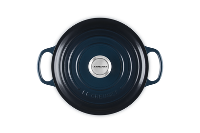 Blue cast iron cookware with a brand logo on a white background