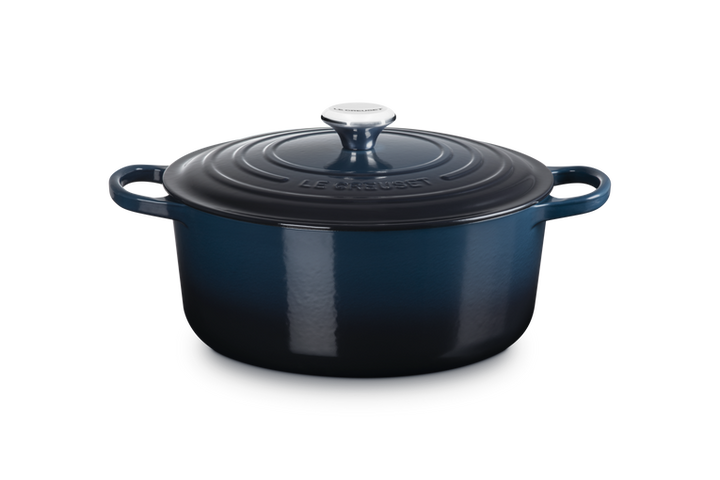 Blue enameled cast iron Dutch oven on a white background