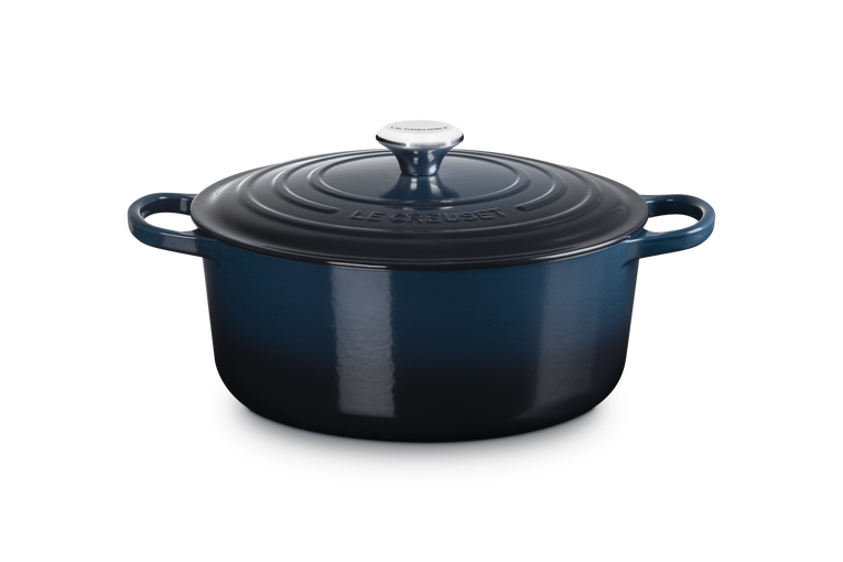 Blue enameled cast iron Dutch oven on a white background