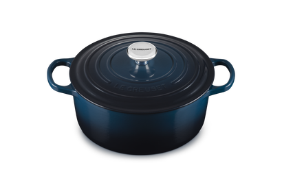 Blue enameled cast iron Dutch oven on a white background