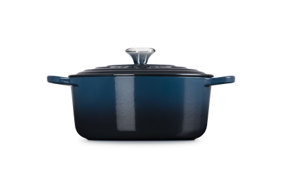 Blue enameled cast iron Dutch oven on a white background