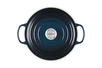 Blue cast iron skillet with handles on a white background