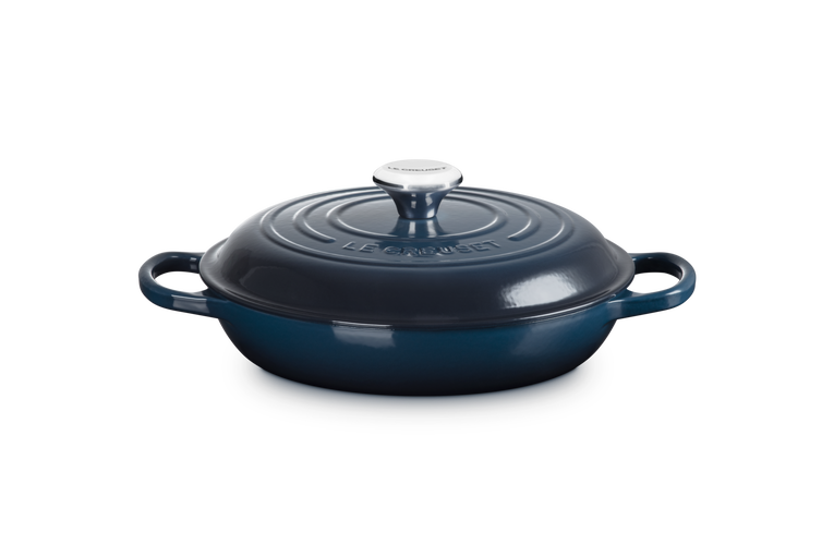 Blue cast iron cookware with lid on a white background
