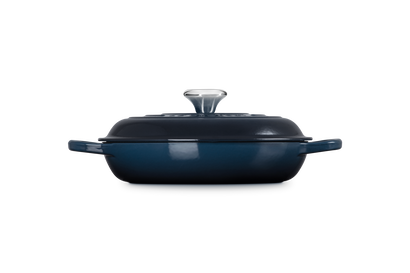 Blue enameled cast iron casserole dish with lid on a white background