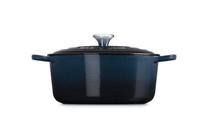 Blue enameled cast iron Dutch oven on a white background