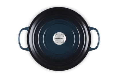 Blue cast iron skillet with handles on a white background