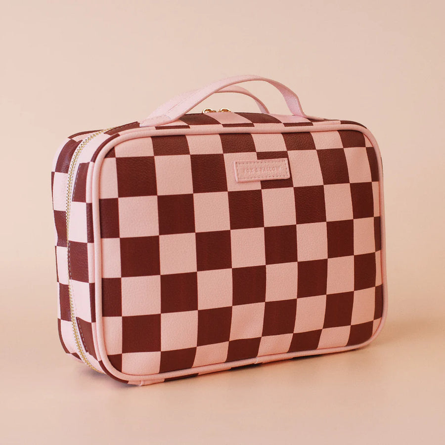 Checkered makeup bag with a visible brand label on a beige background