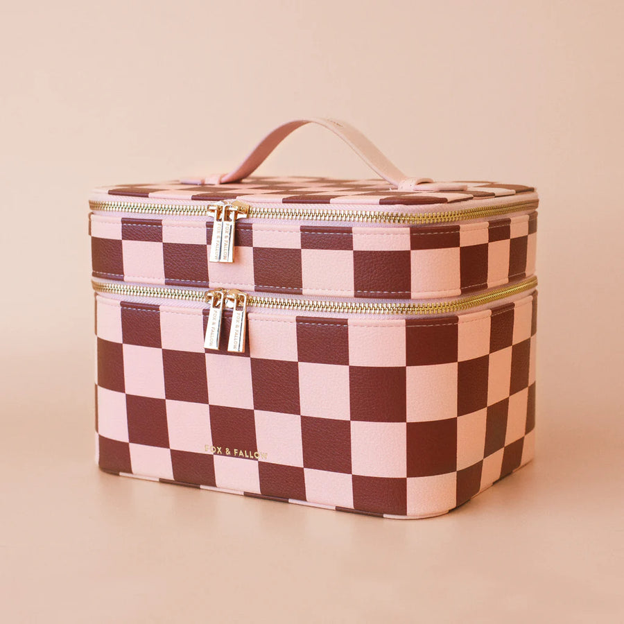 Checkered makeup bag with gold zipper on a beige background