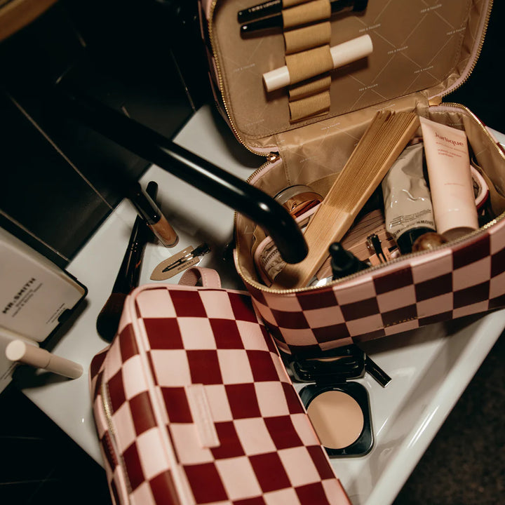 Makeup bag with various cosmetic items on a sink