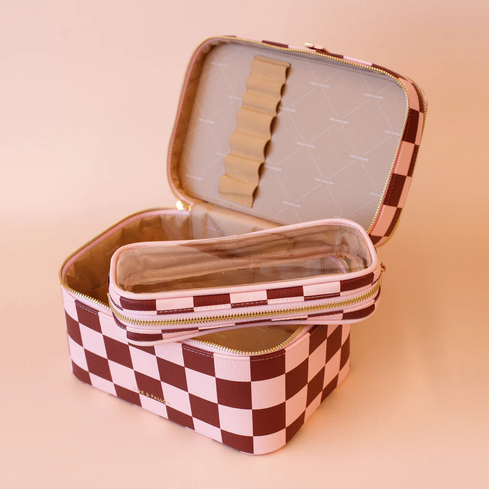 Checkered makeup case with open lid on a beige background