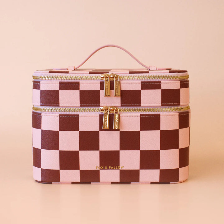 Checkered makeup bag with gold zippers on a beige background