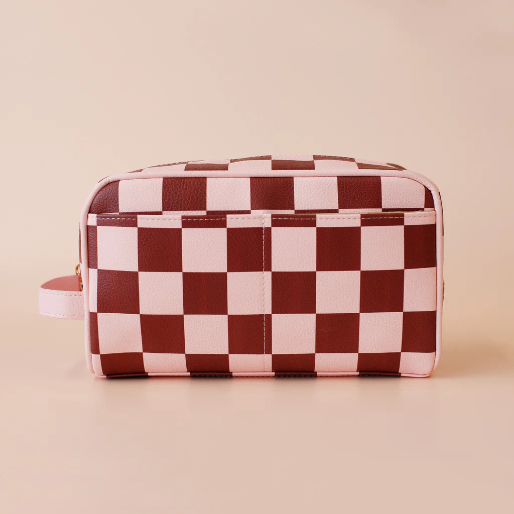 Checkered toiletry bag on a beige background
