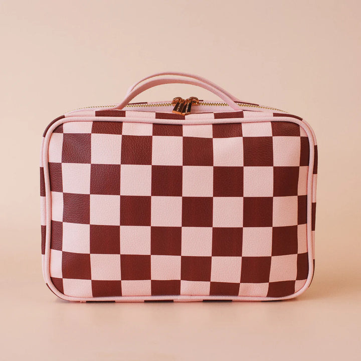 Checkered cosmetic bag with pink and brown pattern on a beige background