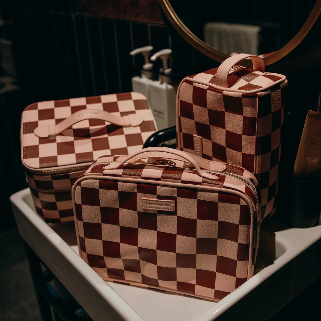 Checkered makeup bags on a tray with a blurred background