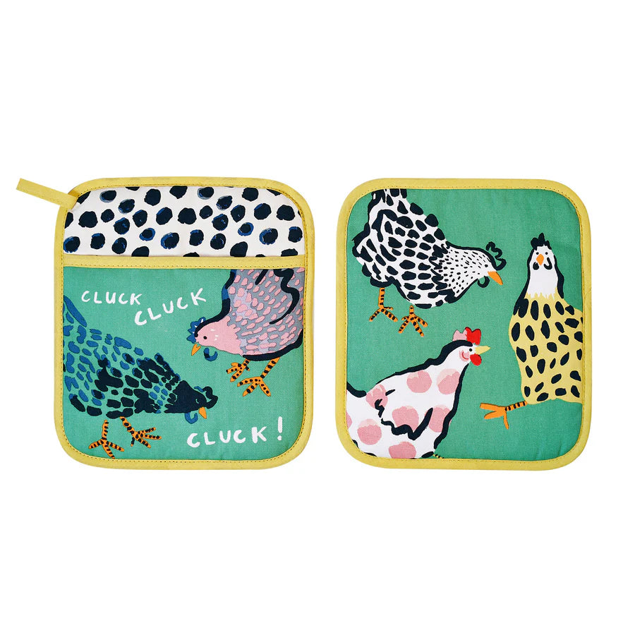 Two pot holders with chicken designs on a green background