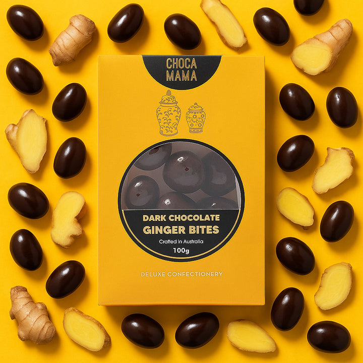 Box of ChocaMama Dark Chocolate Ginger Bites surrounded by ginger pieces on a yellow background