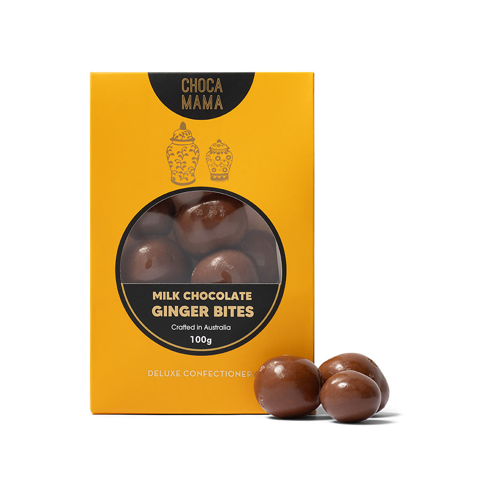 Box of ChocaMama Milk Chocolate Ginger Bites with two ginger bites in front on a white background