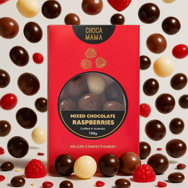 Red box of Choca Mama mixed chocolate raspberries surrounded by assorted chocolates on a light background