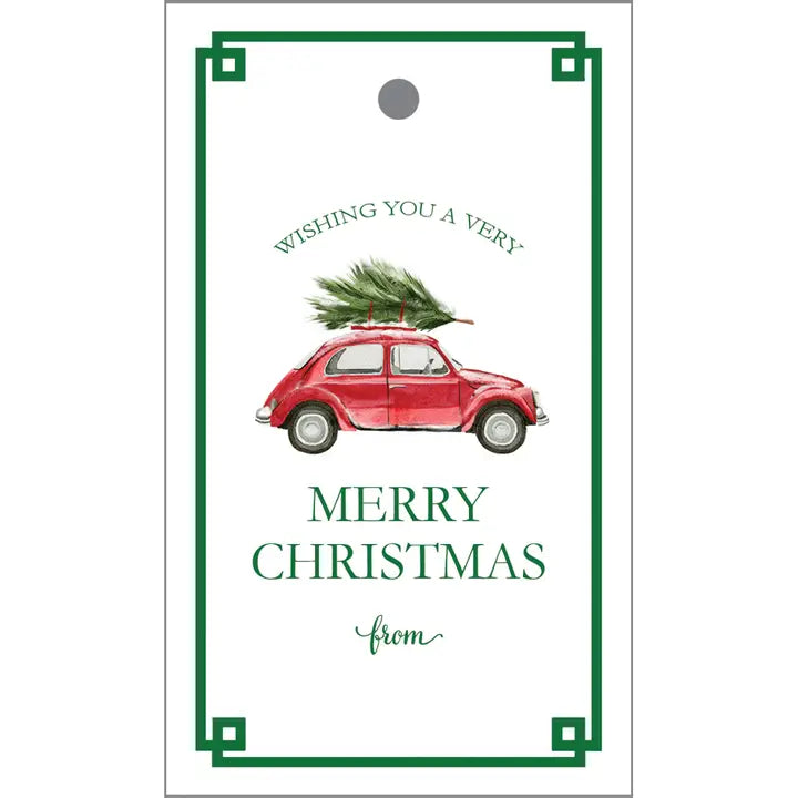 Christmas card with a red car carrying a Christmas tree and text &