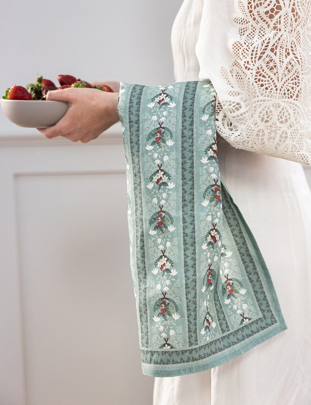 Christmas theme tea towel over someones arm