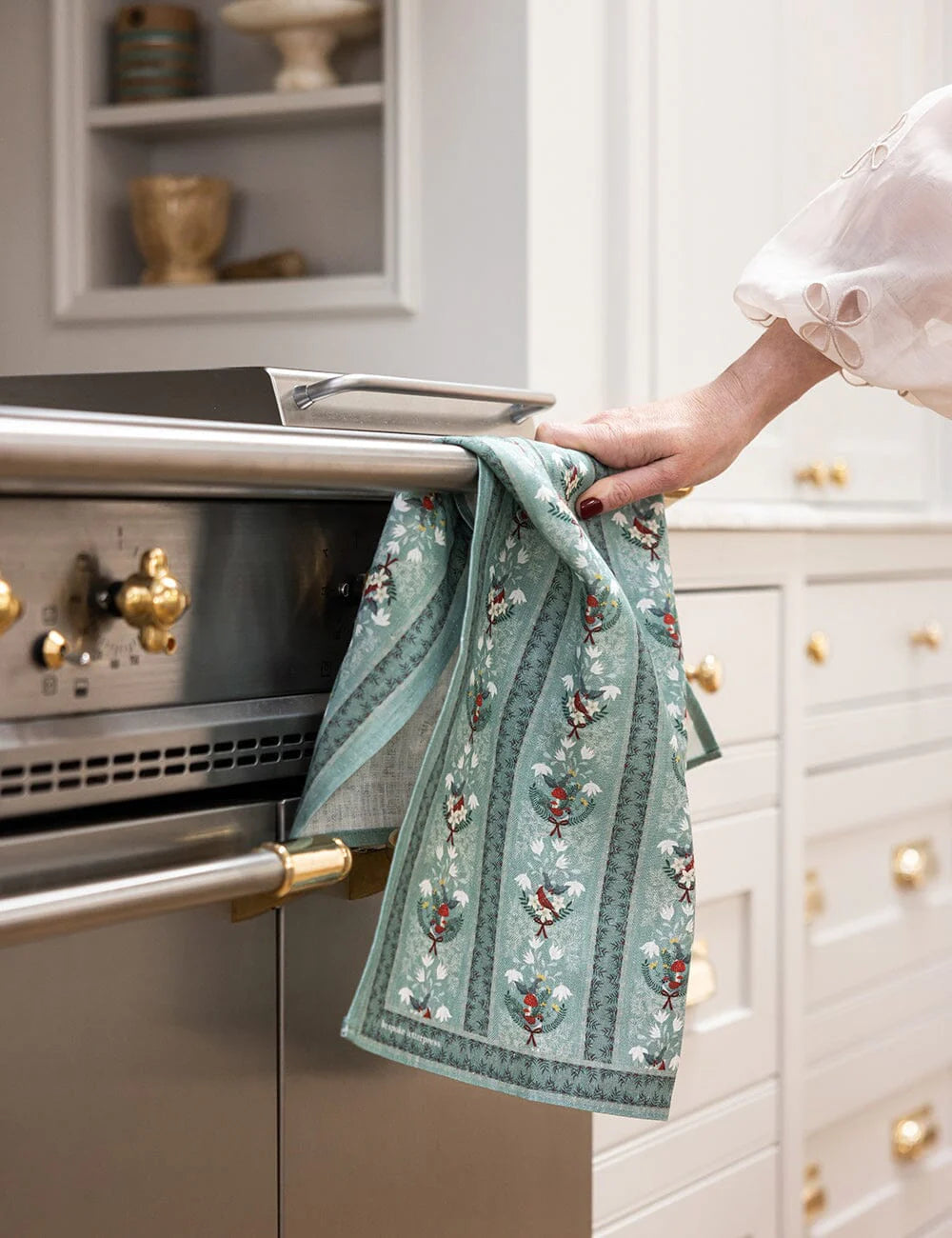 Christmas theme linen tea towel on an oven door handle 