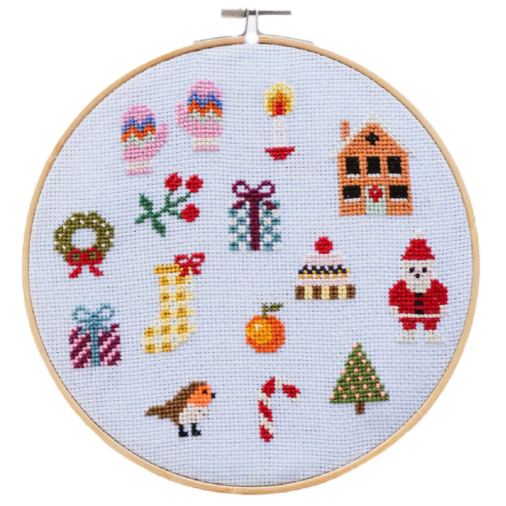 Cross-stitched Christmas-themed design on a white background