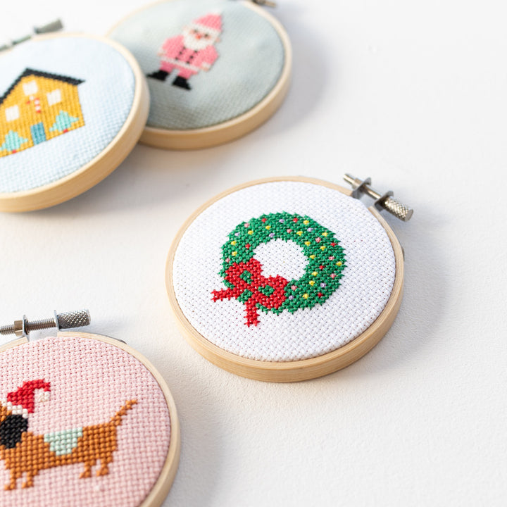 Cross-stitched Christmas-themed hoop art on a light surface