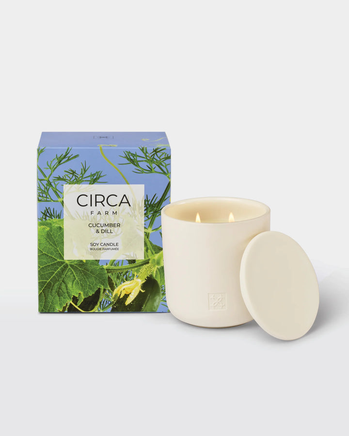 Candle with packaging featuring &