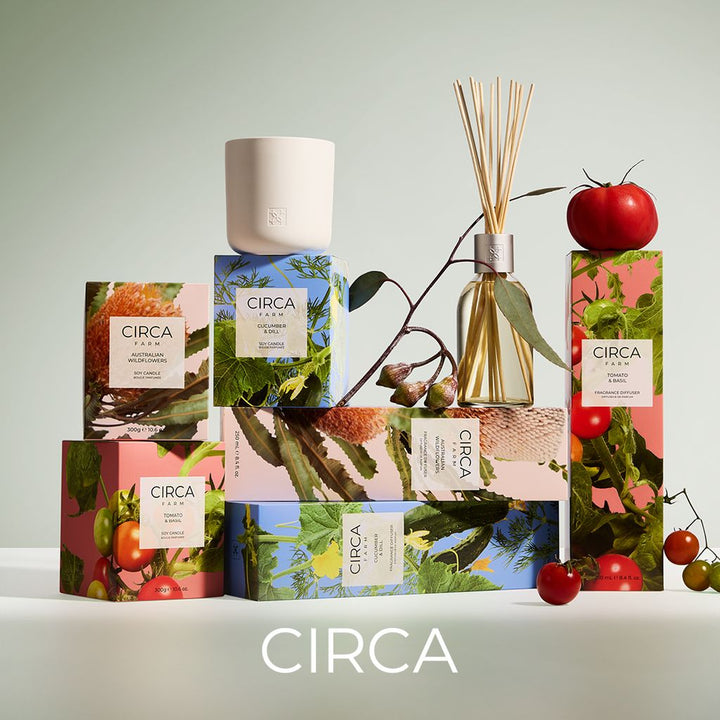 Circa home fragrance products including candles and diffusers with fruit and plant imagery on packaging.