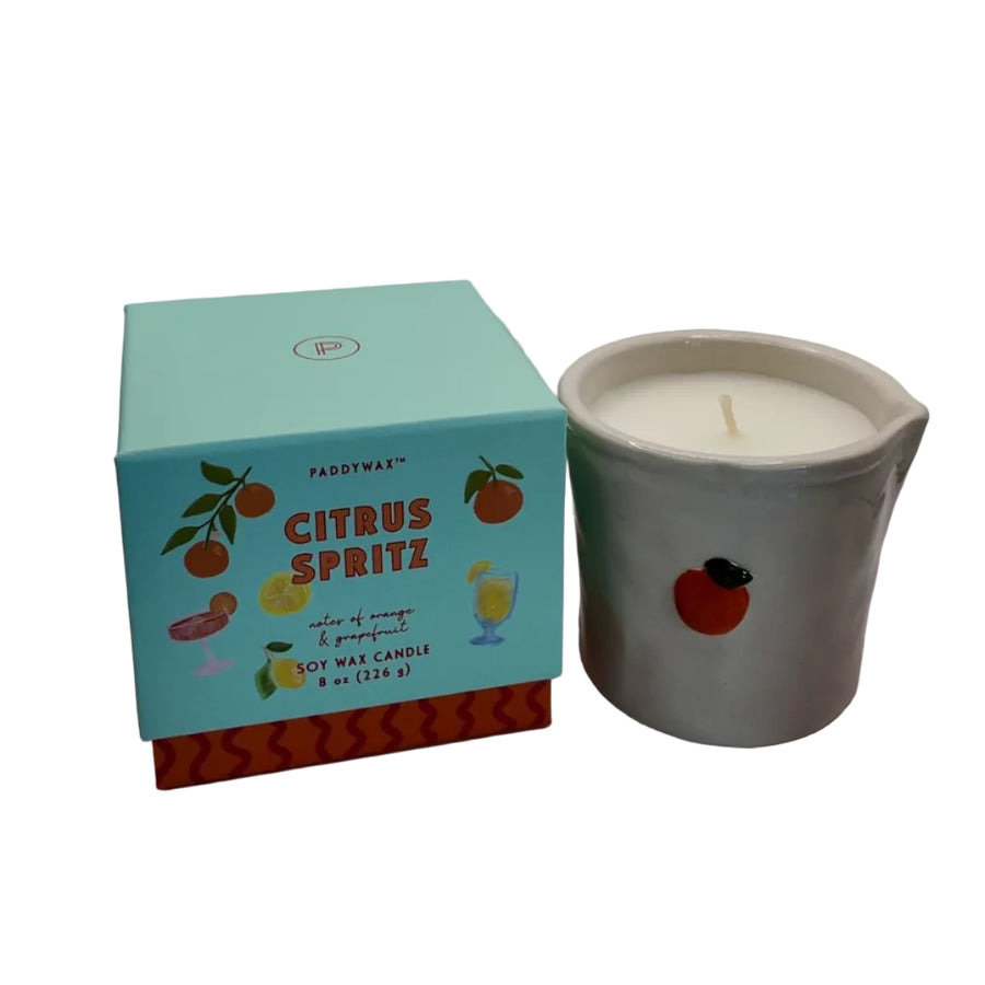 Candle with a box labeled 'Citrus Spritz' on a white background