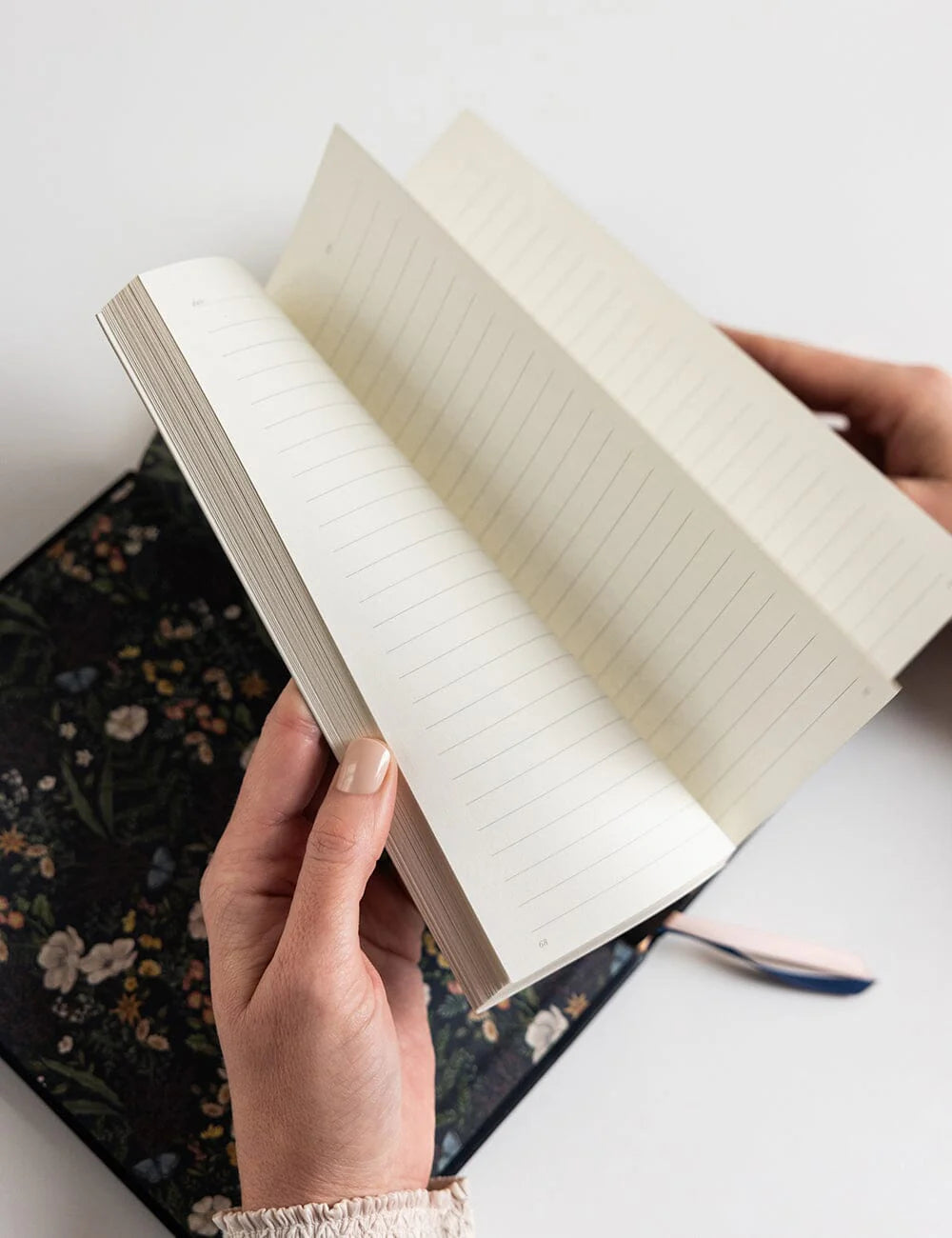 Open notebook held by a person with a blurred background