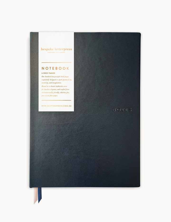Black notebook with a white label on a white background