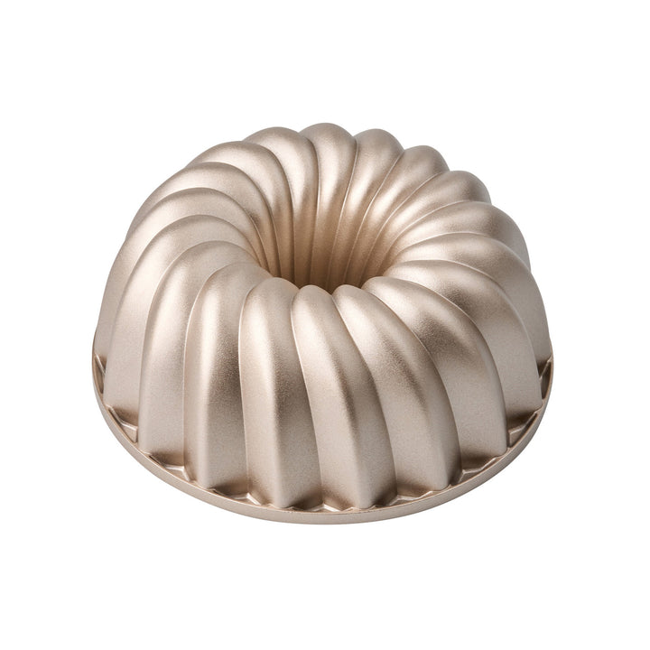 Metallic Bundt cake mold on a white background