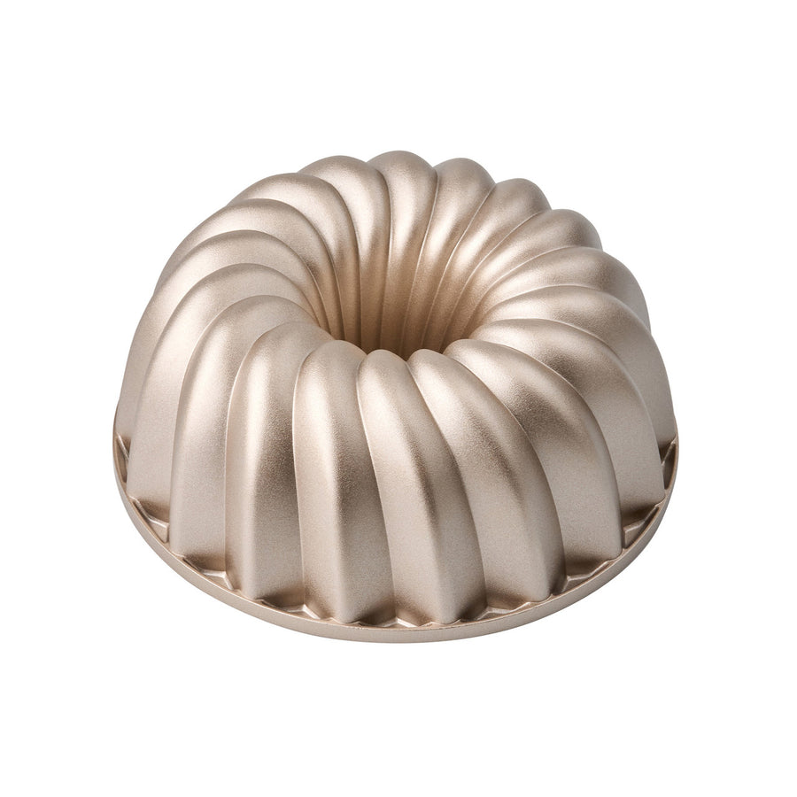Metallic Bundt cake mold on a white background