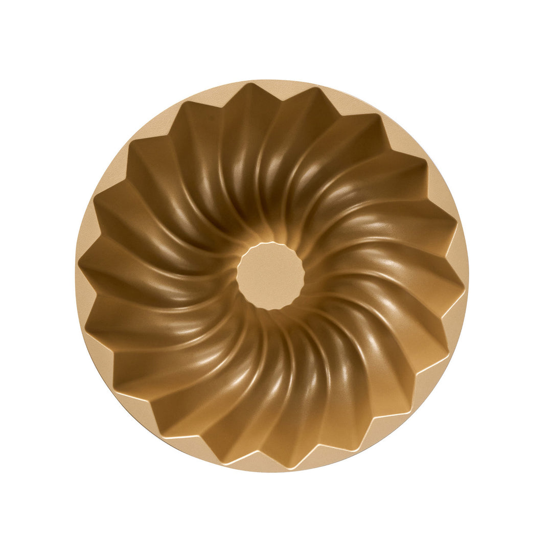 Metallic Bundt cake mold on a white background