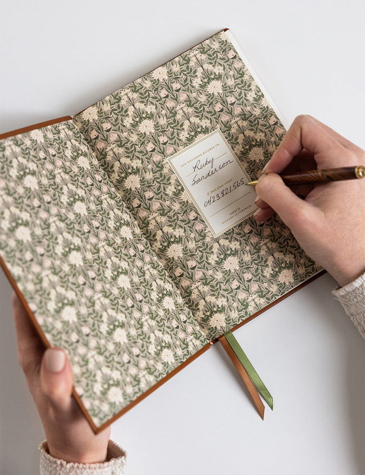 Handwritten card inside a floral-patterned notebook