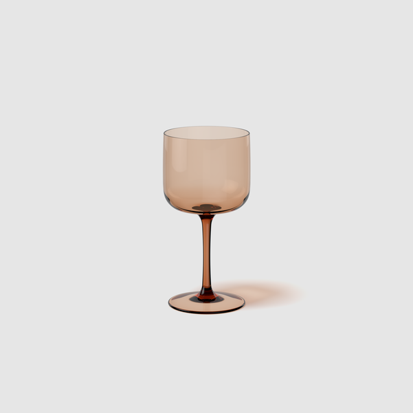 Brown wine glass on a light gray background