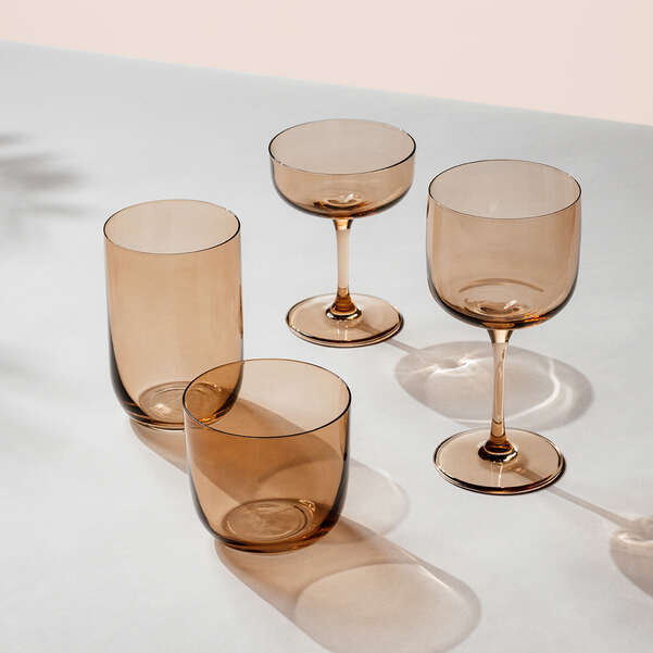 Set of four brown glassware items on a light gray surface